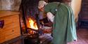 Housemaid stoking the fire at Anne of Cleves House