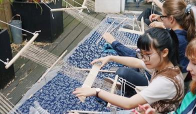 Working on a backstrap loom