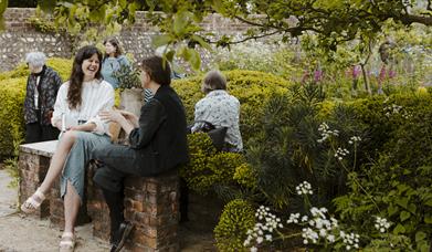 People sitting in the Charleston walled garden