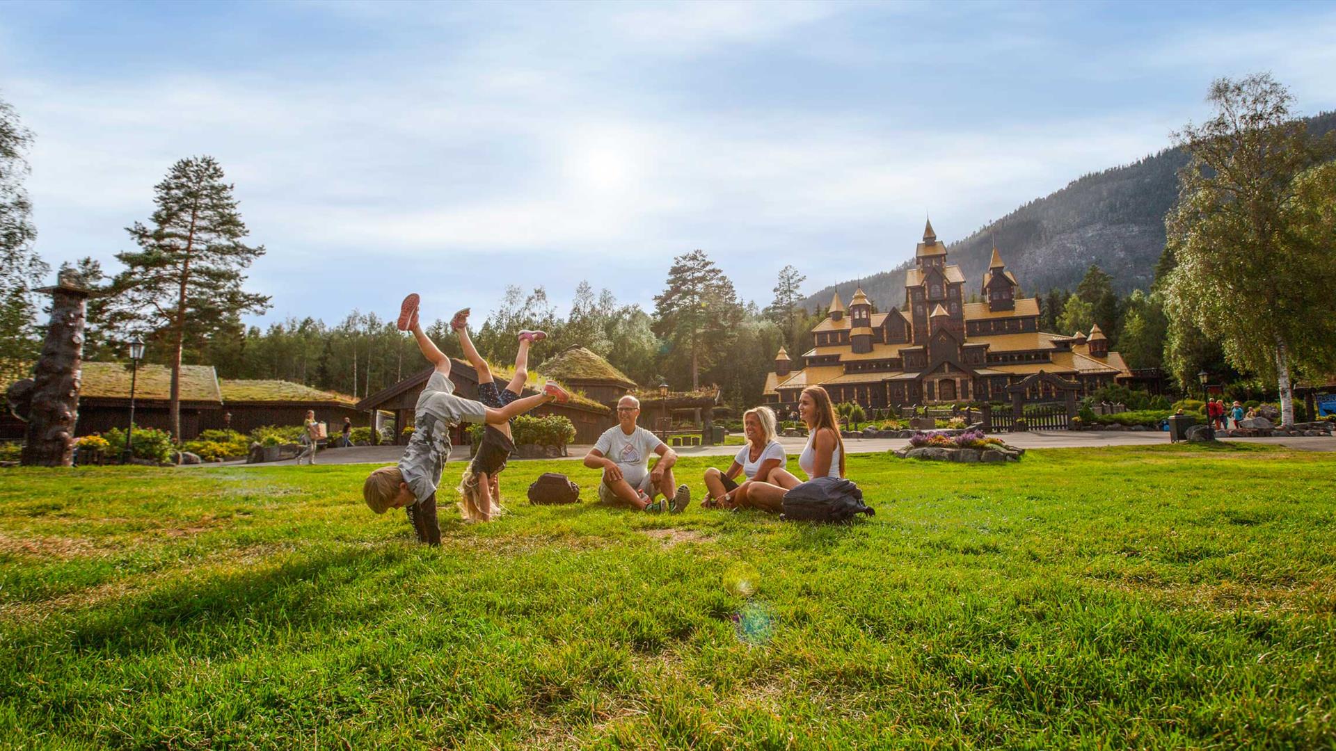 Family in front of the fairytale castle in Hunderfossen Adventure park