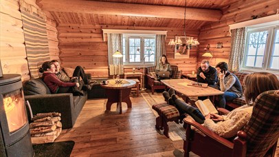 A group of friends sit in a cabin lounge