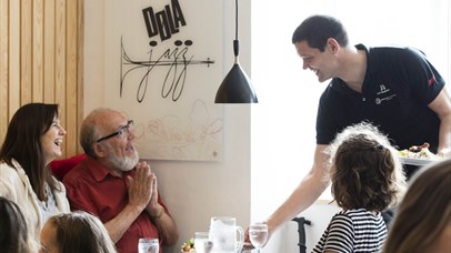 The host, Geir, serve guests at Stasjonen Cafe & Restaurant