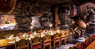 Dining tables at Trollsalen Restaurant at Hunderfossen Eventyrpark where the trolls are holding the celling up on their shoulders