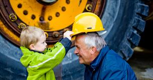 Boy put his helmet on grandfather - Norwegian Rock Blasting Museum Hunderfossen