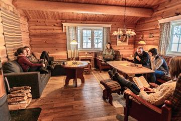 A group of friends sit in a cabin lounge