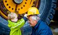 Boy put his helmet on grandfather - Norwegian Rock Blasting Museum Hunderfossen