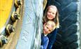 Children behind a big tractor wheel