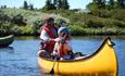 Father and son padling on the lake