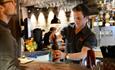 Bartender serving customer at Heim Gastropub