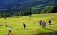 Golf players at the putting course at Nermo