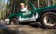 The boys enjoying driving car in the mud