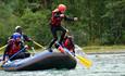 Rafting and river activities in a forested canyon.