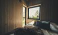 Bedroom with views of forest and nature.