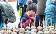 Girl eating chockolate covered apple.