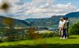 Golfers overlooking the landscape.