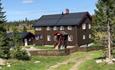 A large brown building by the Ohldhølen lake which in earlier times where used as an mountain farm dairy.