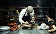 The chef plates up a dish at Pellestova Restaurant