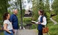 Museum visitors meeting an actor in front of Garmo stave church.