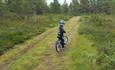 Ei little boy bicycling along a wide path