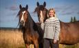 Two Dole horses with their owner