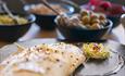 White fish presented on a slate with accompaniments