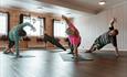 Group practicing pilates in a circle | Venabu Fjellhotell