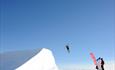 Alpine skier doing a flip from a jump at Skeikampen Skisenter