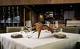 Elegant restaurant table overlooking a wine cellar.