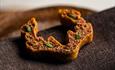 Crispy snack served on a dark cloth.
