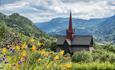 Ringebu Stavechurch with yellow flowers and valley view