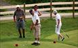 Golf players at the putting course at Nermo