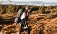 Person with backpack hiking in rugged mountain terrain