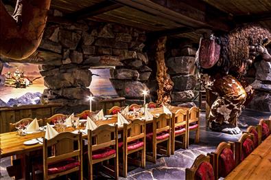 Dining tables at Trollsalen Restaurant at Hunderfossen Eventyrpark where the trolls are holding the celling up on their shoulders