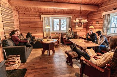 A group of friends sit in a cabin lounge