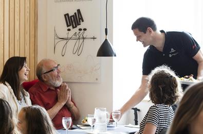 The host, Geir, serve guests at Stasjonen Cafe & Restaurant