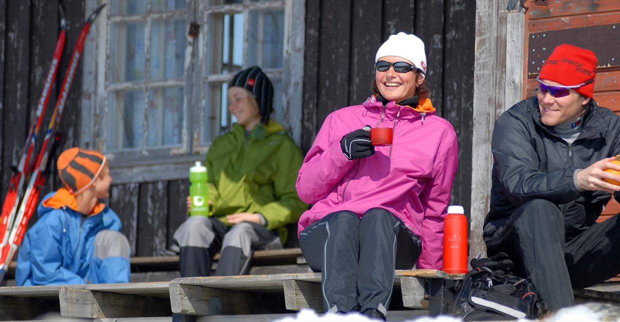 Cross-country skiiers, family taking a break