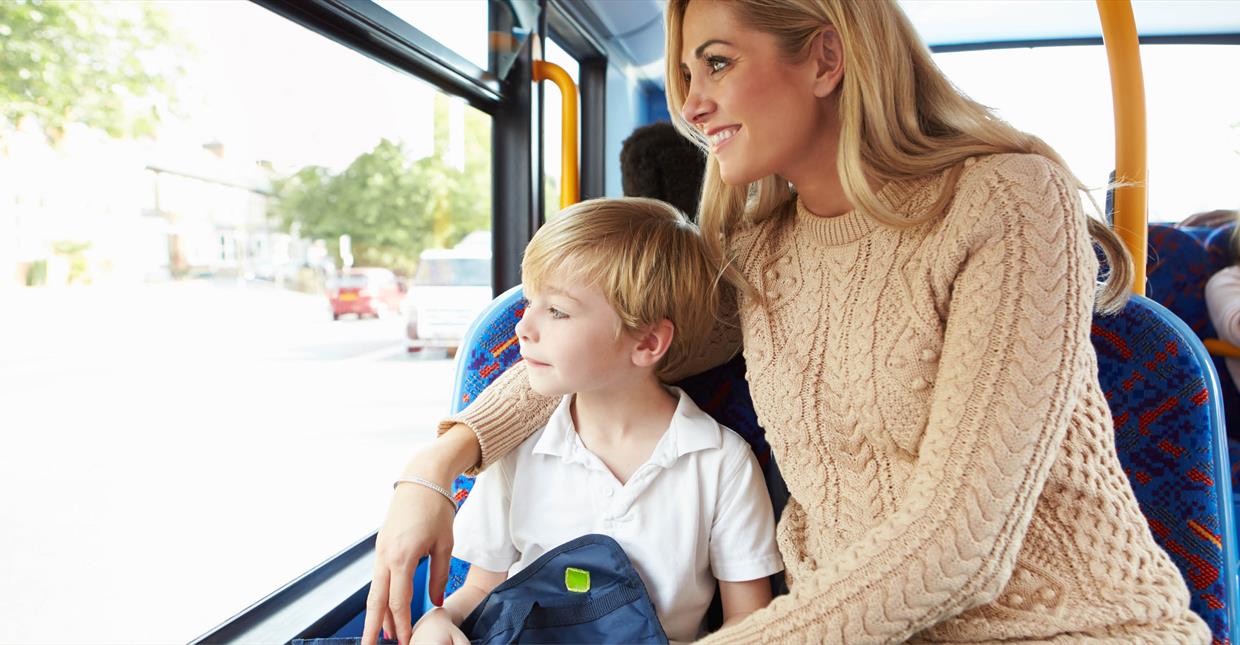 Mother and child looking out the window on the bus.