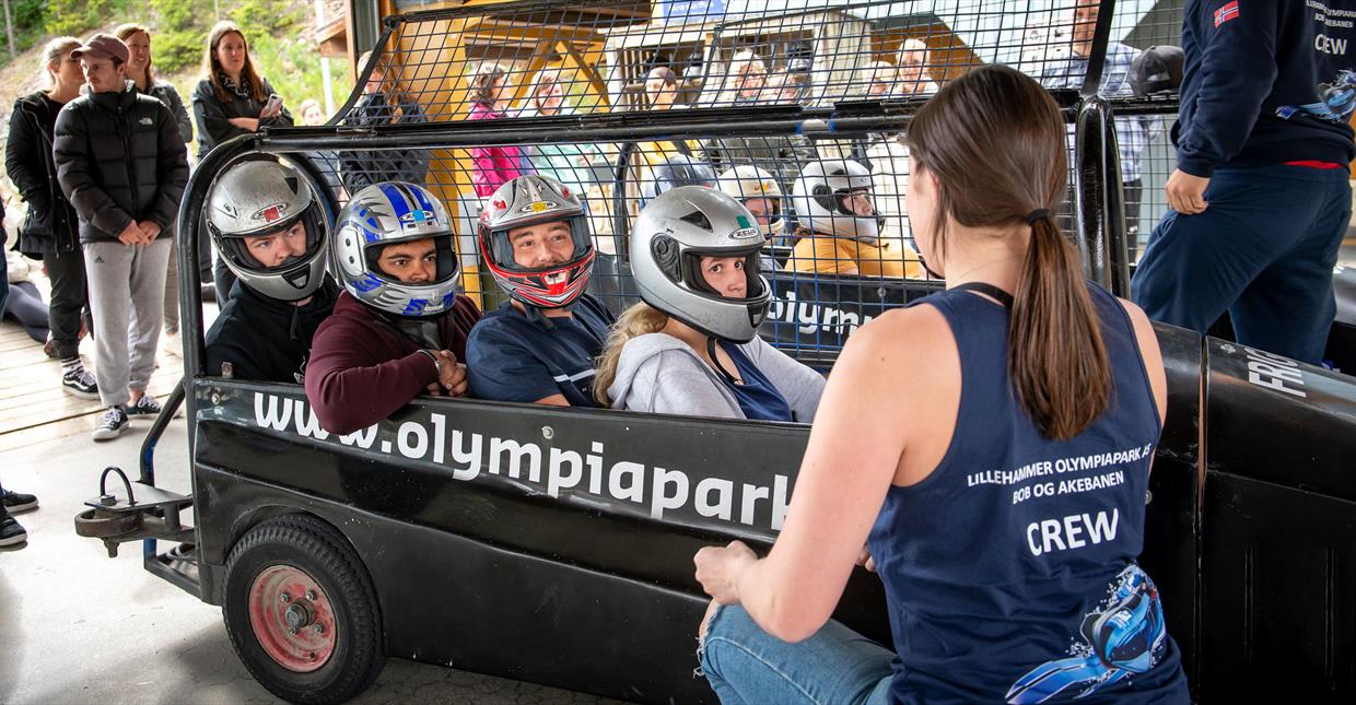 Getting instruction on how to behave in the bobsleigh on wheels.