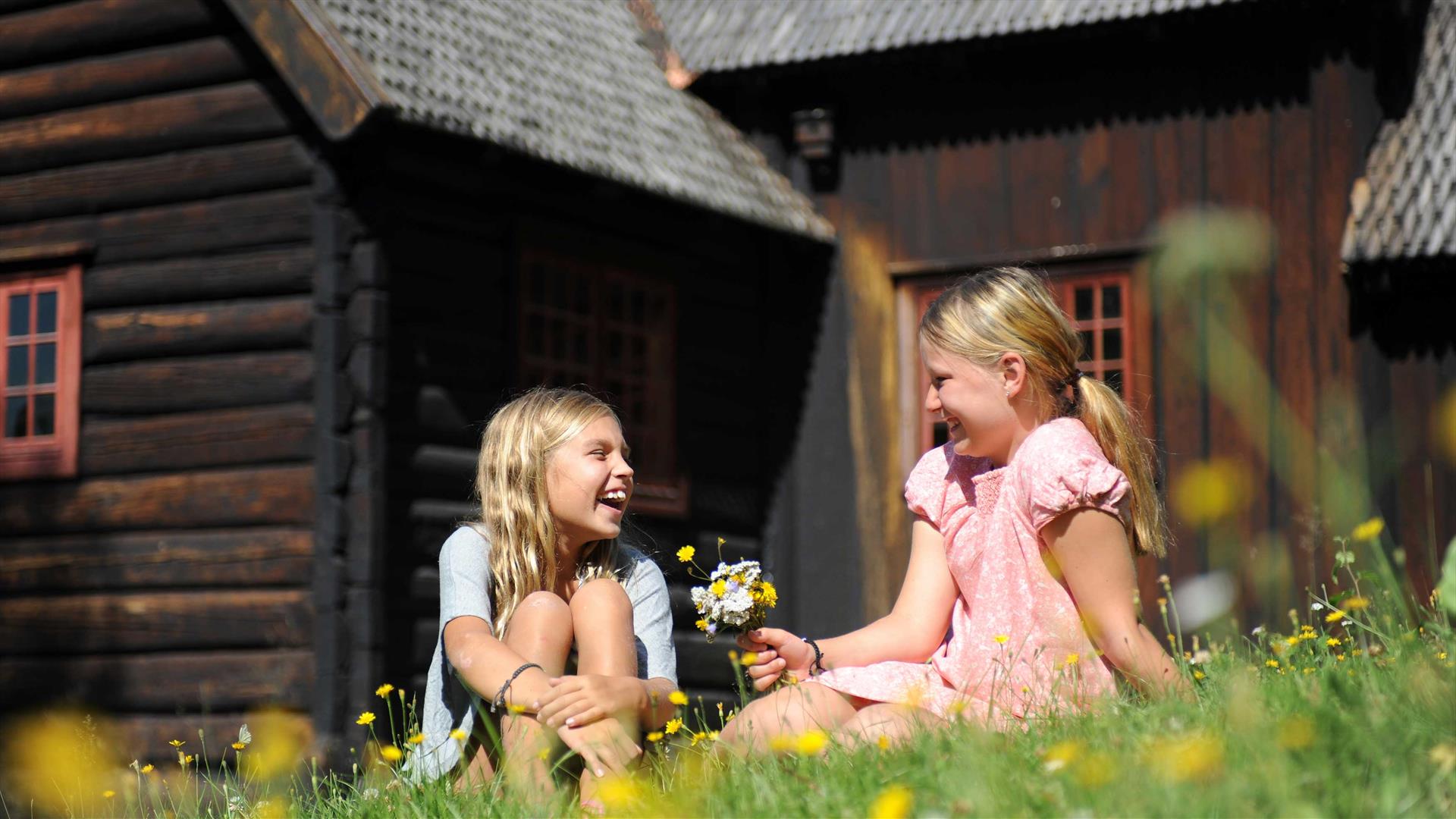 Girls in front of Garmo Stave Church at Maihaugen Outdoor Museum