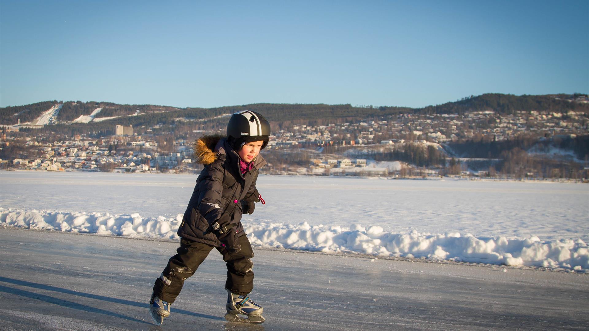 Kid ice skating on the lake Mjøsa