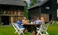 Guests enjoying a cup of coffee around a table outside at Sygaard Grytting