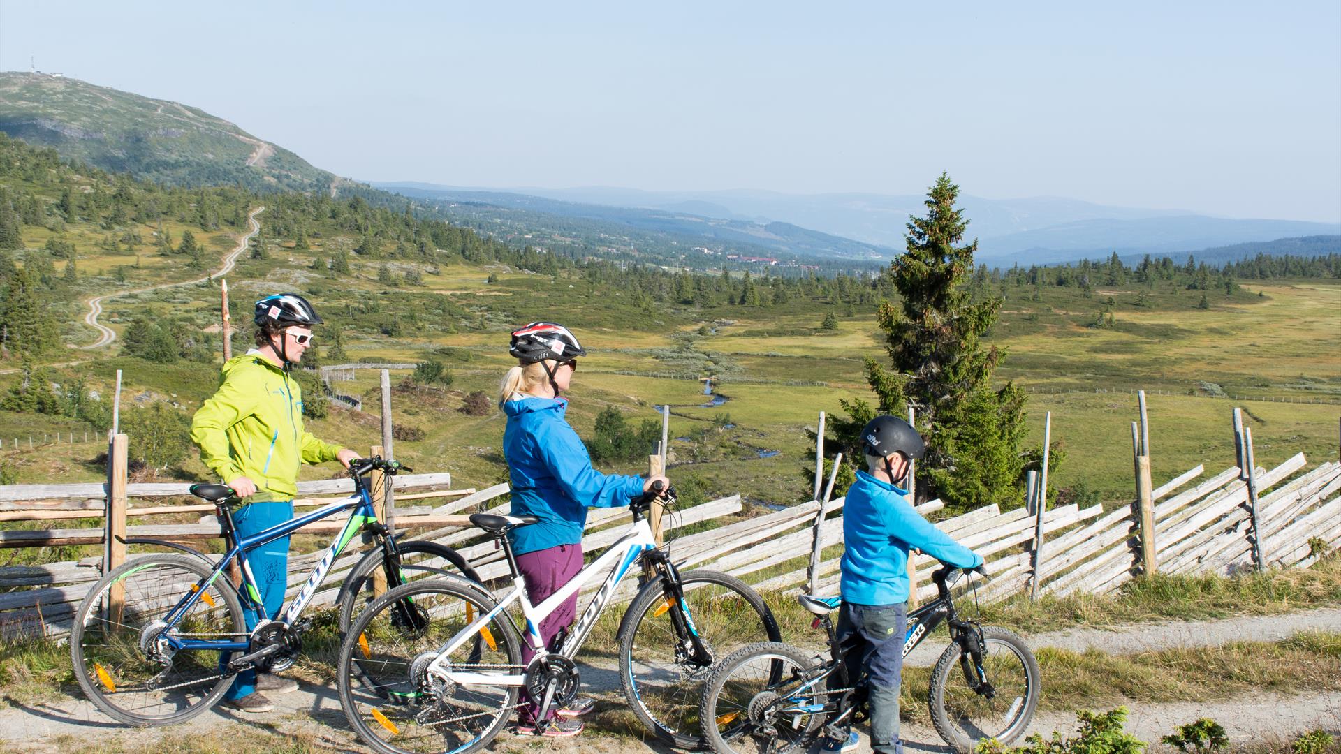 A family biking in the mountain farm landscape.