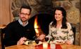 Guests who enjoy their dinner in front of the fireplace at Hafjell hotel / Hafjell Ressort