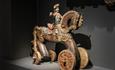 Carved horse toy with wheels and rider.