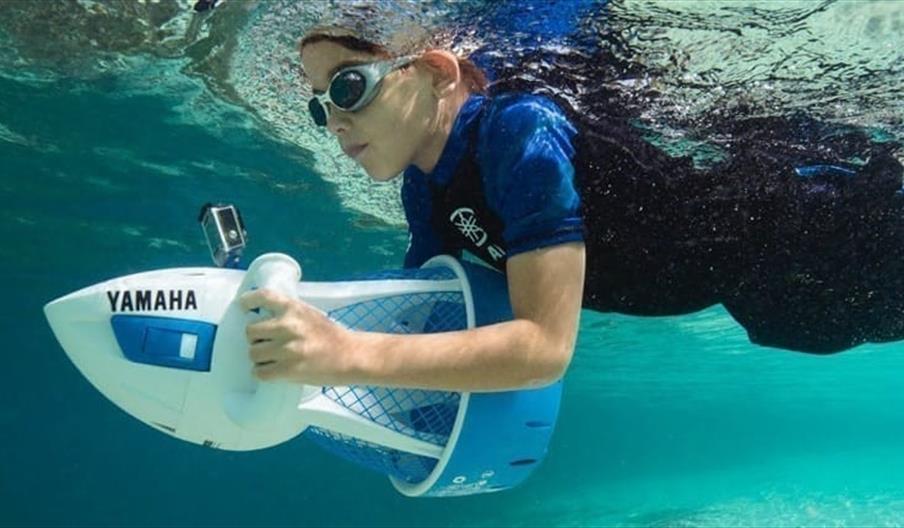 Image of child with sea scooter in pool