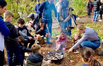 Image of children around camp fire