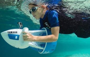 Image of child with sea scooter in pool