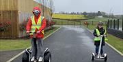 Image of adult and child on segway