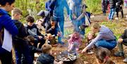 Image of children around camp fire