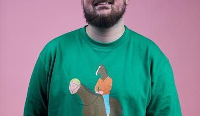 image of a bearded man wearing a green jumper